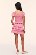 Tween pink Fabielle top, back view with puff sleeves and smocked ruffle layers