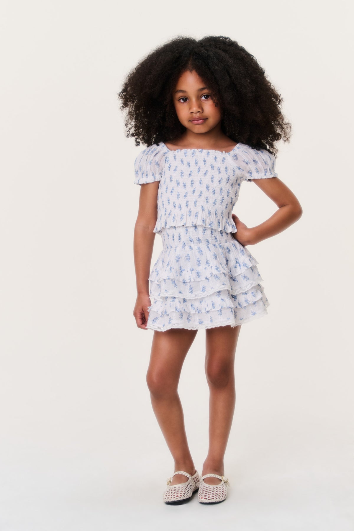 Girls indigo cloud short tiered ruffle skirt on model, light blue pattern