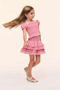 Girls’ pink smocked top with puff sleeves and tiered ruffle hem, side view