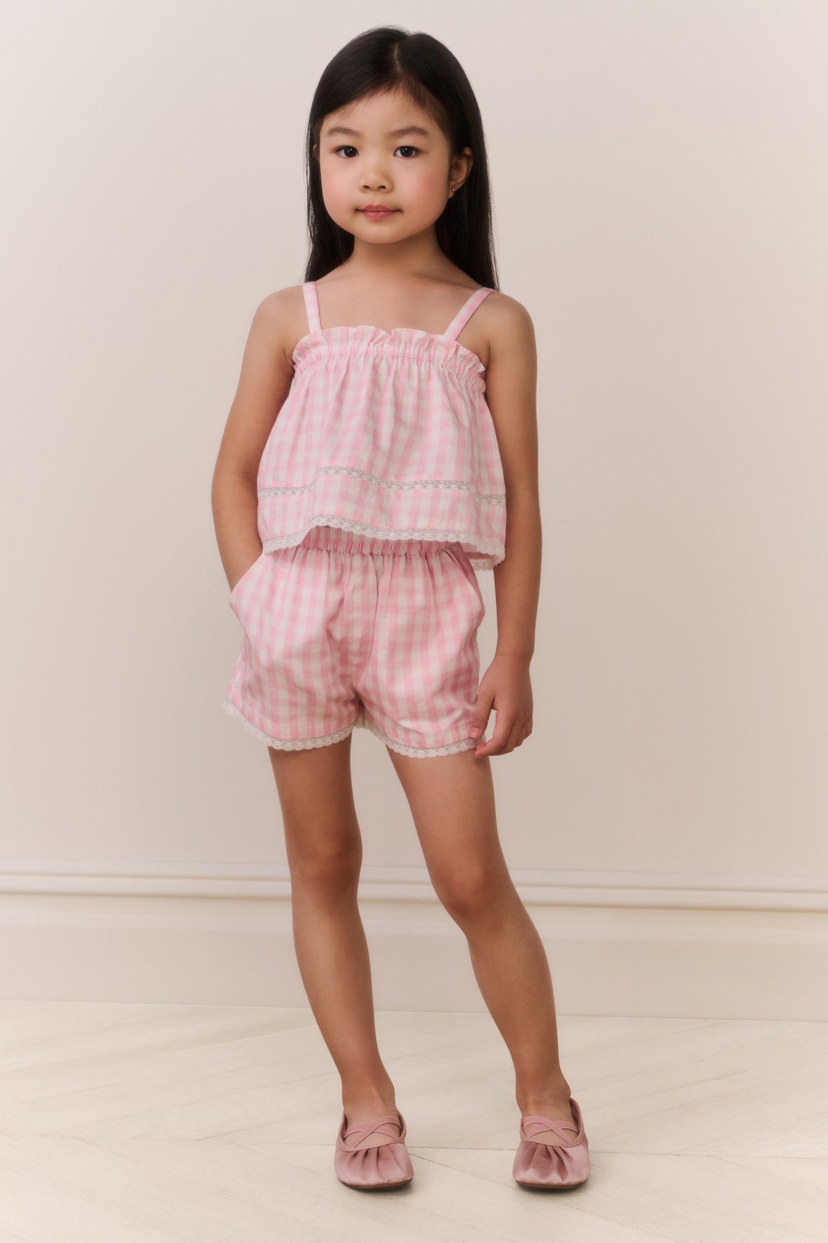Girls pink gingham ruffle camisole top with tiered ruffle layers and thin straps