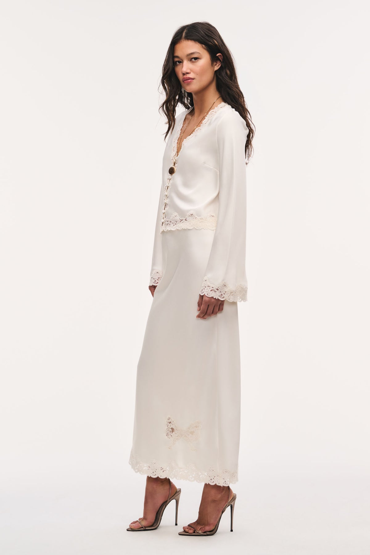 Cream crepe top with lace-trimmed sleeve cuffs and curved lace hem