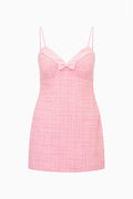 Pink tweed mini dress with spaghetti straps and front bow detail
