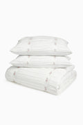 White embroidered duvet cover and matching shams set with floral details