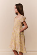 Yellow floral tiered dress with square neckline and puff sleeves, side view