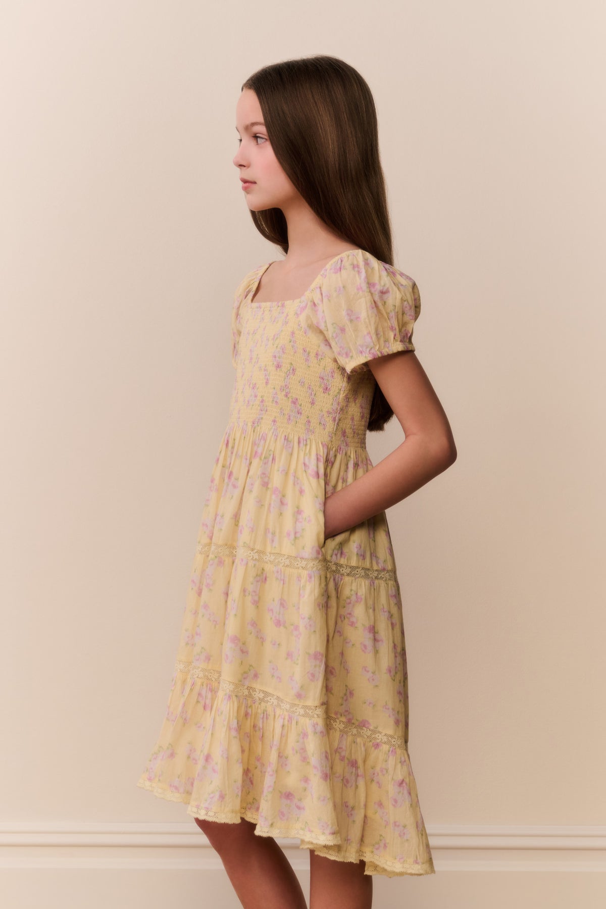 Yellow floral tiered dress with square neckline and puff sleeves, side view