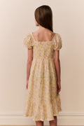Yellow floral tiered dress from back view with square neckline and puff sleeves