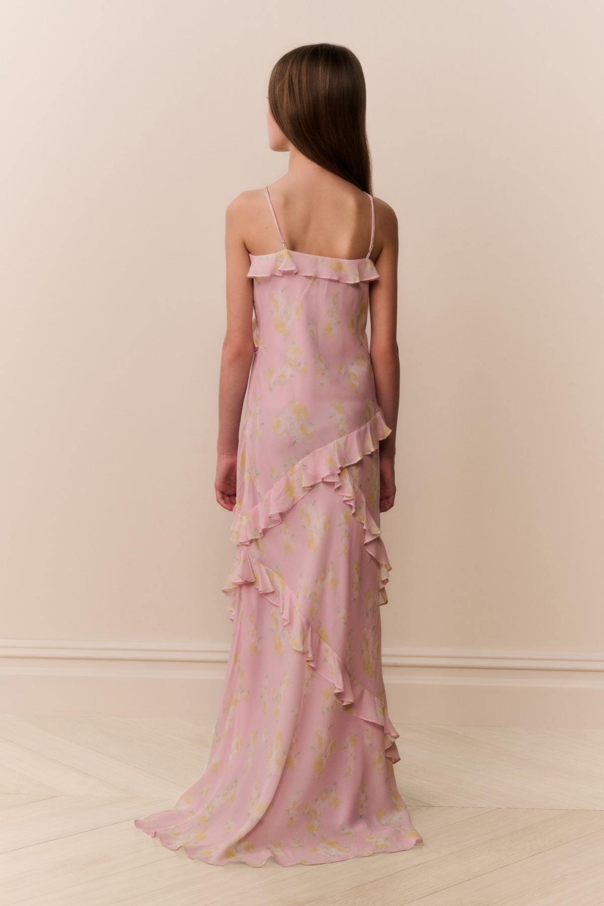 Back view pink floral chiffon tween dress with thin straps and tiered ruffle hem