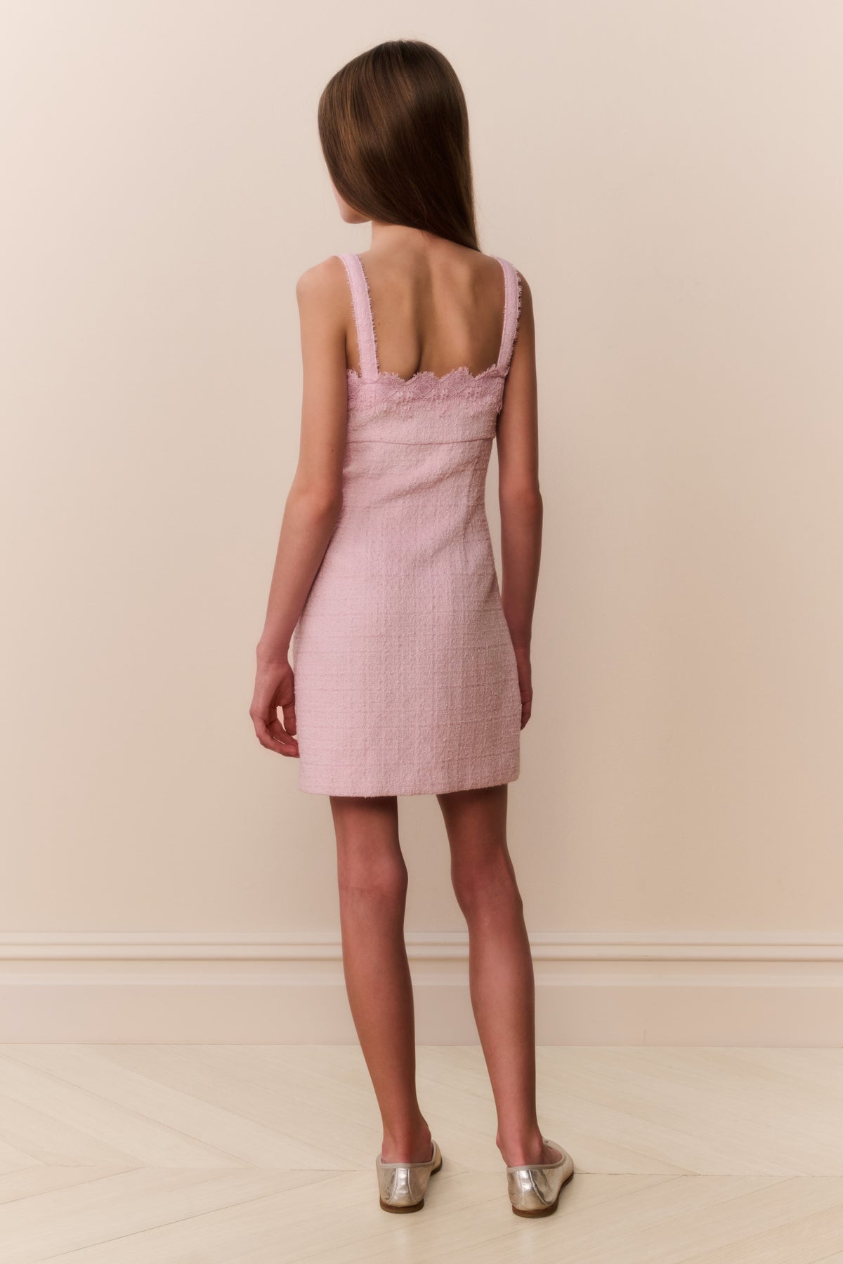 Pink sleeveless mini dress with lace straps and open-back detail