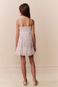 White cotton lace-trimmed cami dress, back view with spaghetti straps and tiered skirt