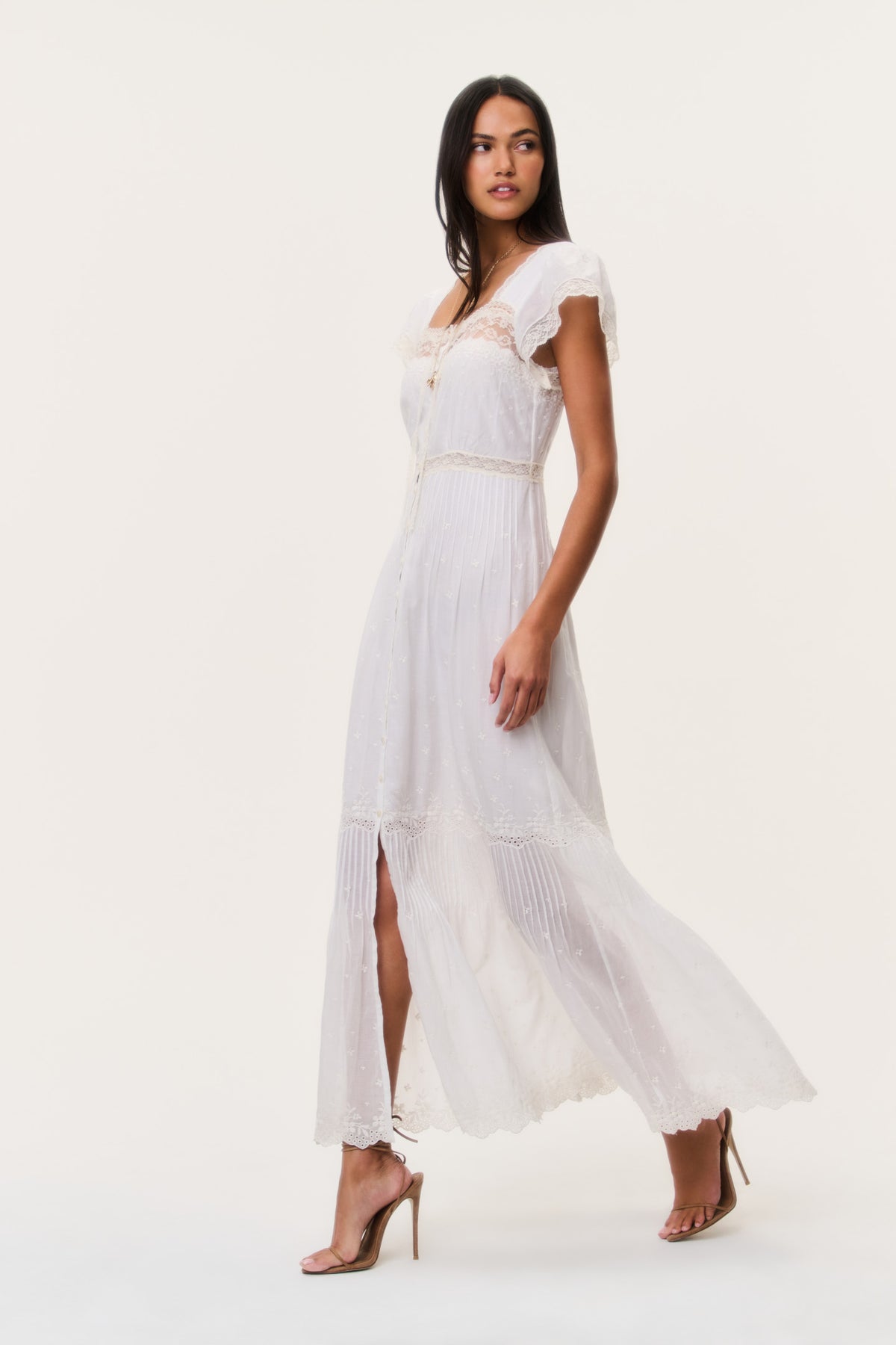 Ivory cotton lace maxi dress with cap sleeves, button front, and sheer hem panels