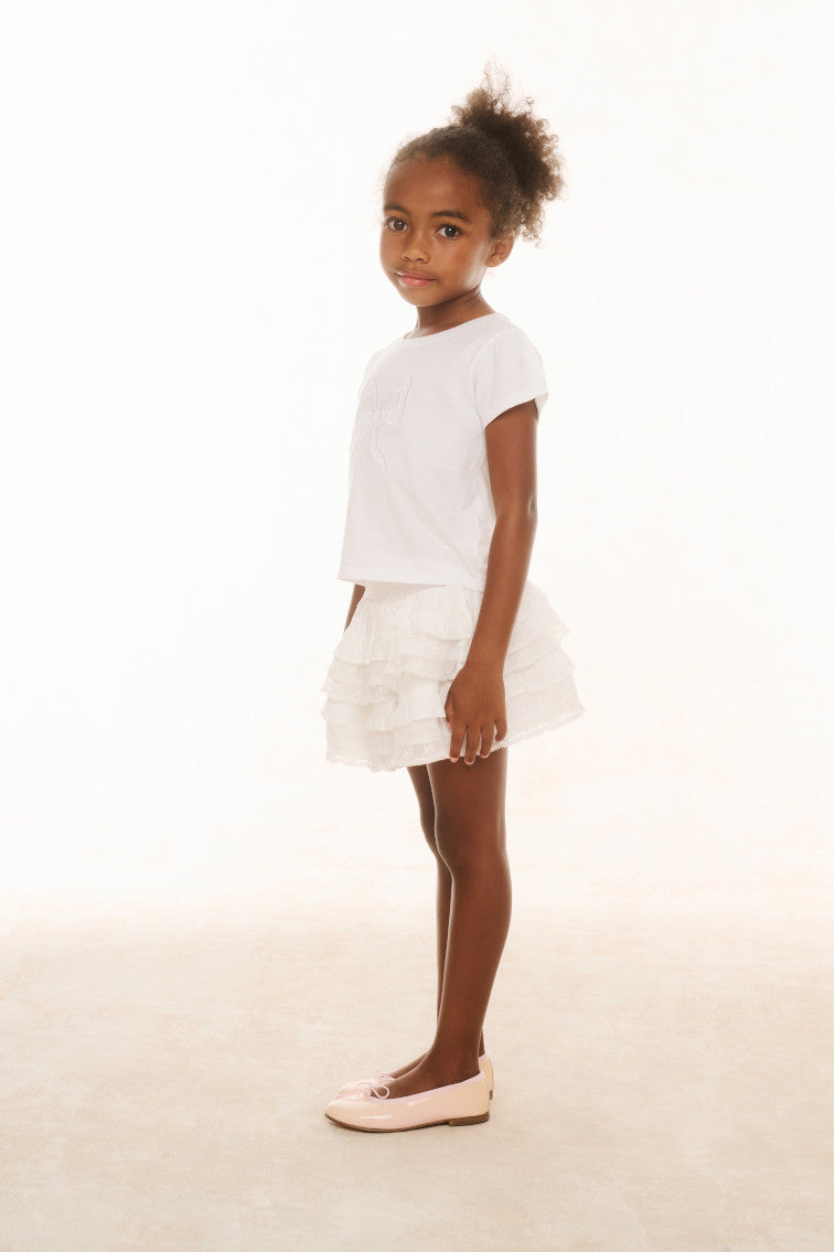 Girls white tiered ruffle skirt with elastic waistband, side view