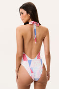 Backless halter one-piece swimsuit with patchwork print in white, blue, and pink.