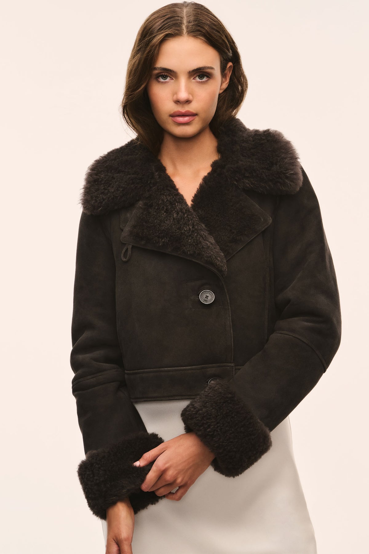 Cropped dark shearling jacket with wide fur collar and button-down placket