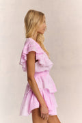 Pink mini dress with V-neck, tiered ruffles, and short ruffle sleeves