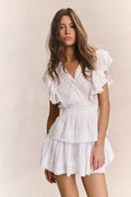 White mini dress with V-neck and short ruffled sleeves, layered tiered skirt