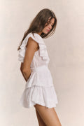 White mini dress with flutter cap sleeves and tiered ruffle skirt