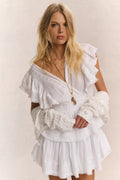 White mini dress with V-neck, ruffled sleeves, tiered skirt