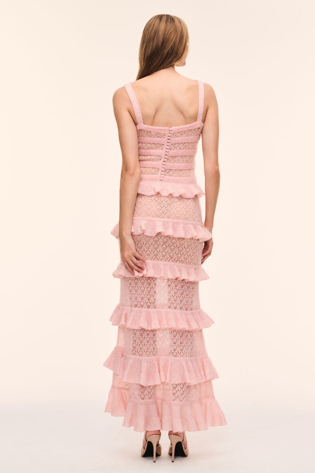 Back view of pink knit tier ruffle dress with lace panels and thin spaghetti straps