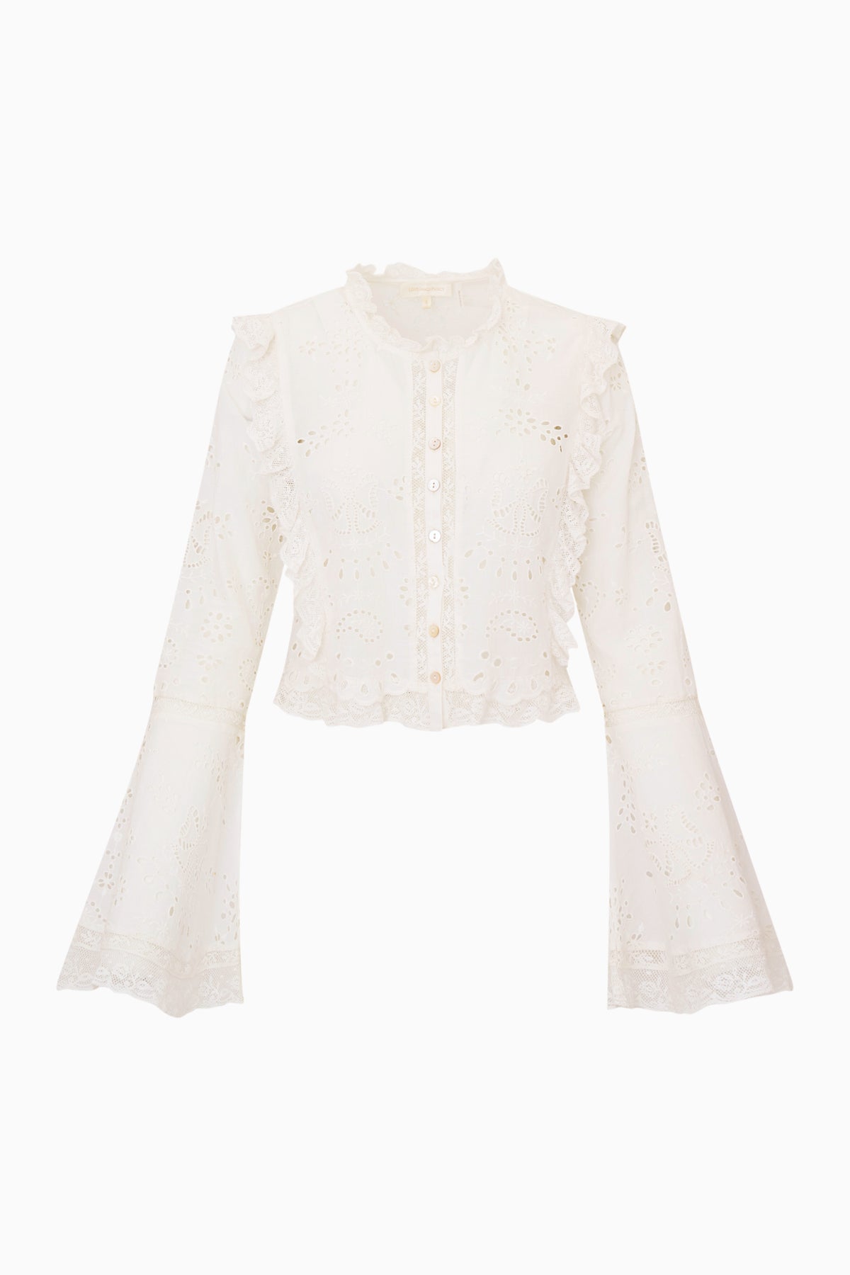 White eyelet cotton blouse flat lay with ruffle trim, long sleeves, and button front