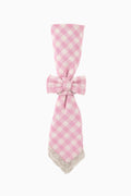 Pink gingham fabric napkin ring with tied bow and scalloped trim