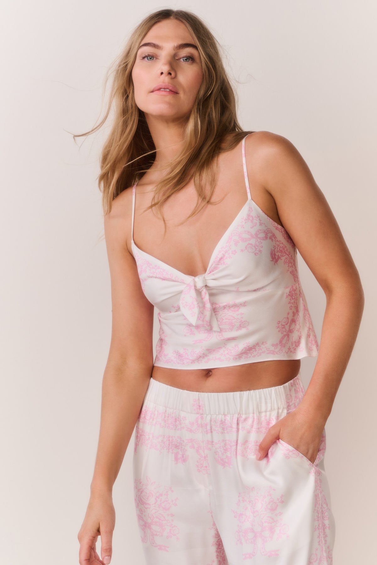 Ivory camisole top with pink floral print, spaghetti straps, bow-front