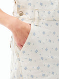 Women’s ecru overall close-up: blue micro-print, front button tab, side pocket