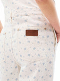 Women’s ecru overall back pocket close-up with stitched design and leather-look patch