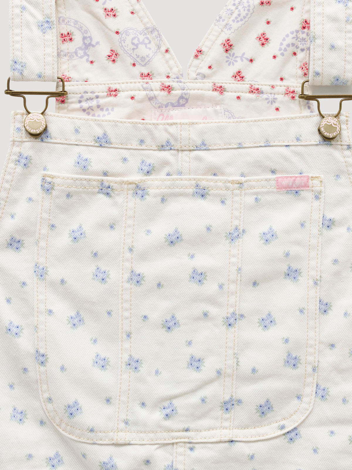 Women’s ecru overall waistband close-up with blue micro-print and patch pocket