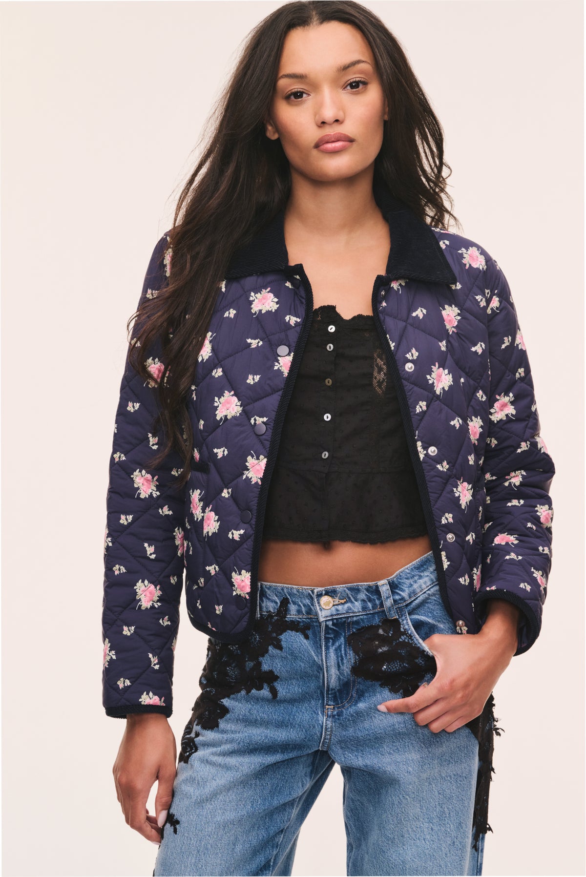 Dark navy floral quilted jacket with zip front and pink flower scattered pattern