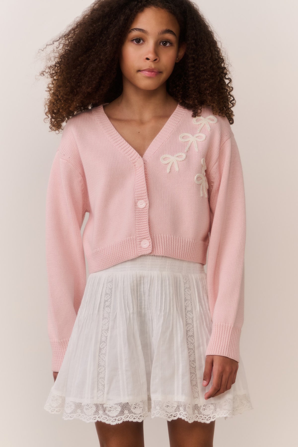 Pink knit cardigan, bow embroidery on chest, button-front V-neck, long sleeves