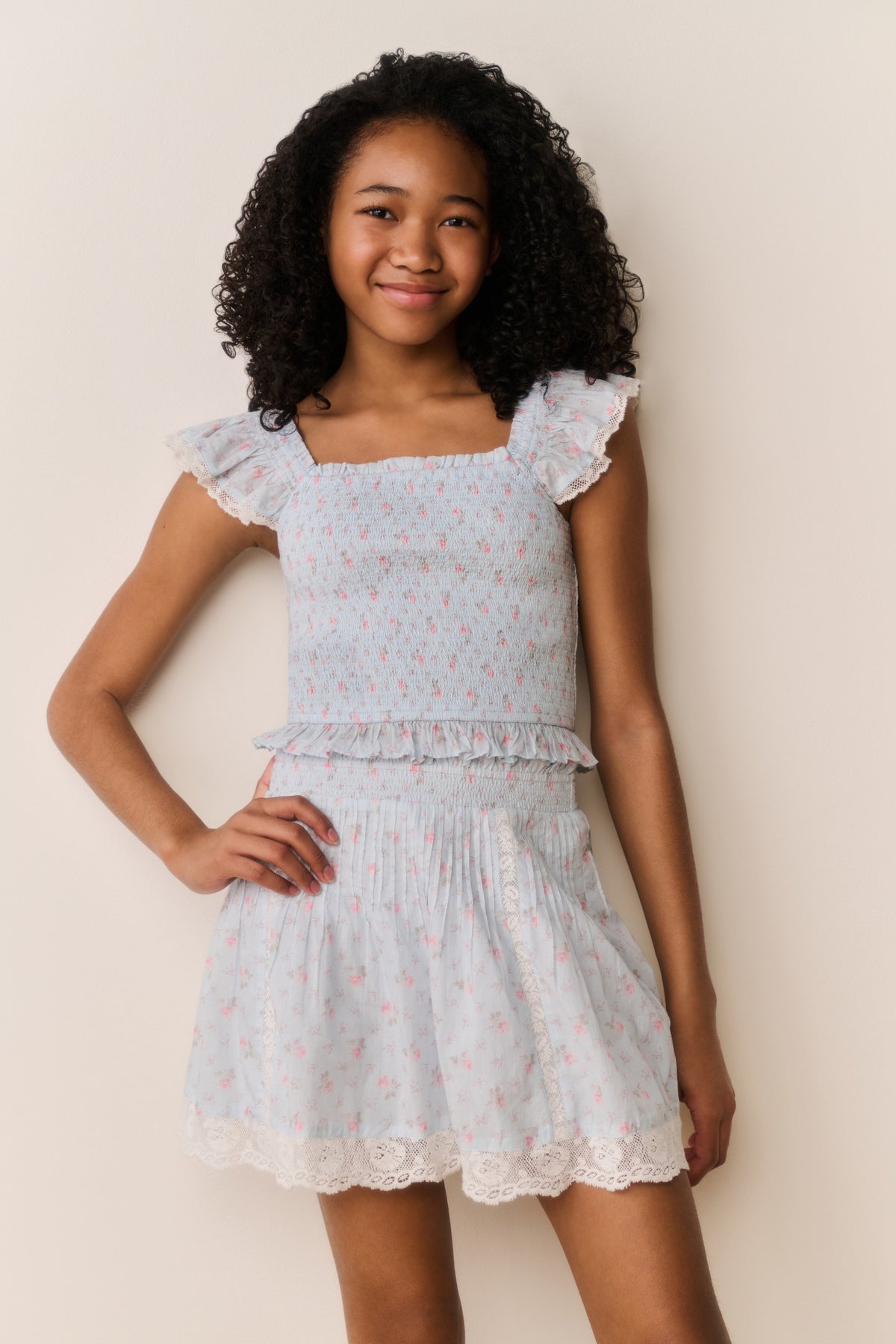Floral cotton top with square neckline, ruffled sleeves, and gathered tiered skirt hem