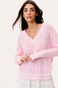 Pink cable knit pullover sweater with V-neck, long sleeves, and striped ribbed hem