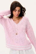 Pink cable knit V-neck pullover with long sleeves and striped hem detail
