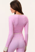 Pink patterned active jacket from back view with long sleeves and cropped hem