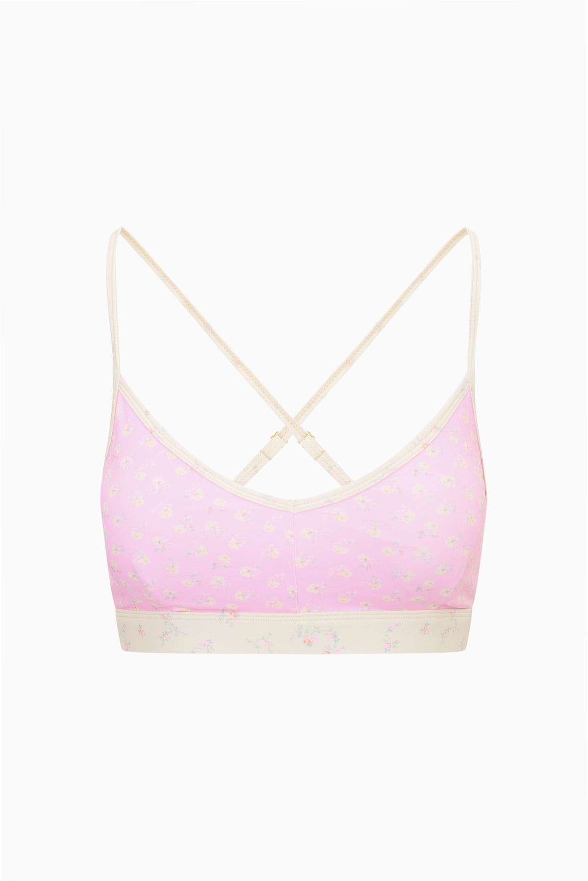 Ditsy floral sports bra with pale base, pink-trim underband and thin crisscross straps