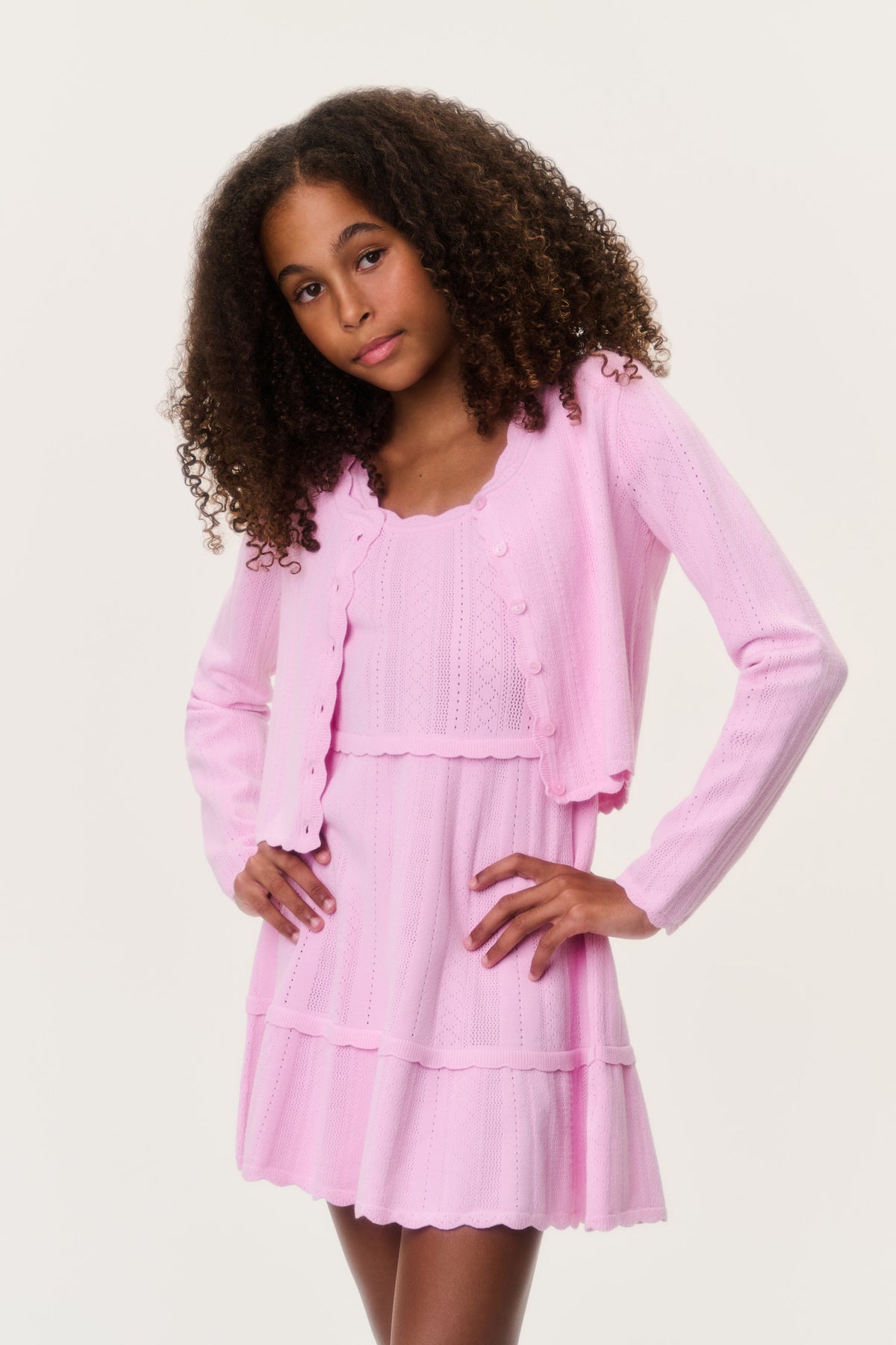 Tween pointelle cardigan, light pink button-front and pointelle knit with ruffle hem