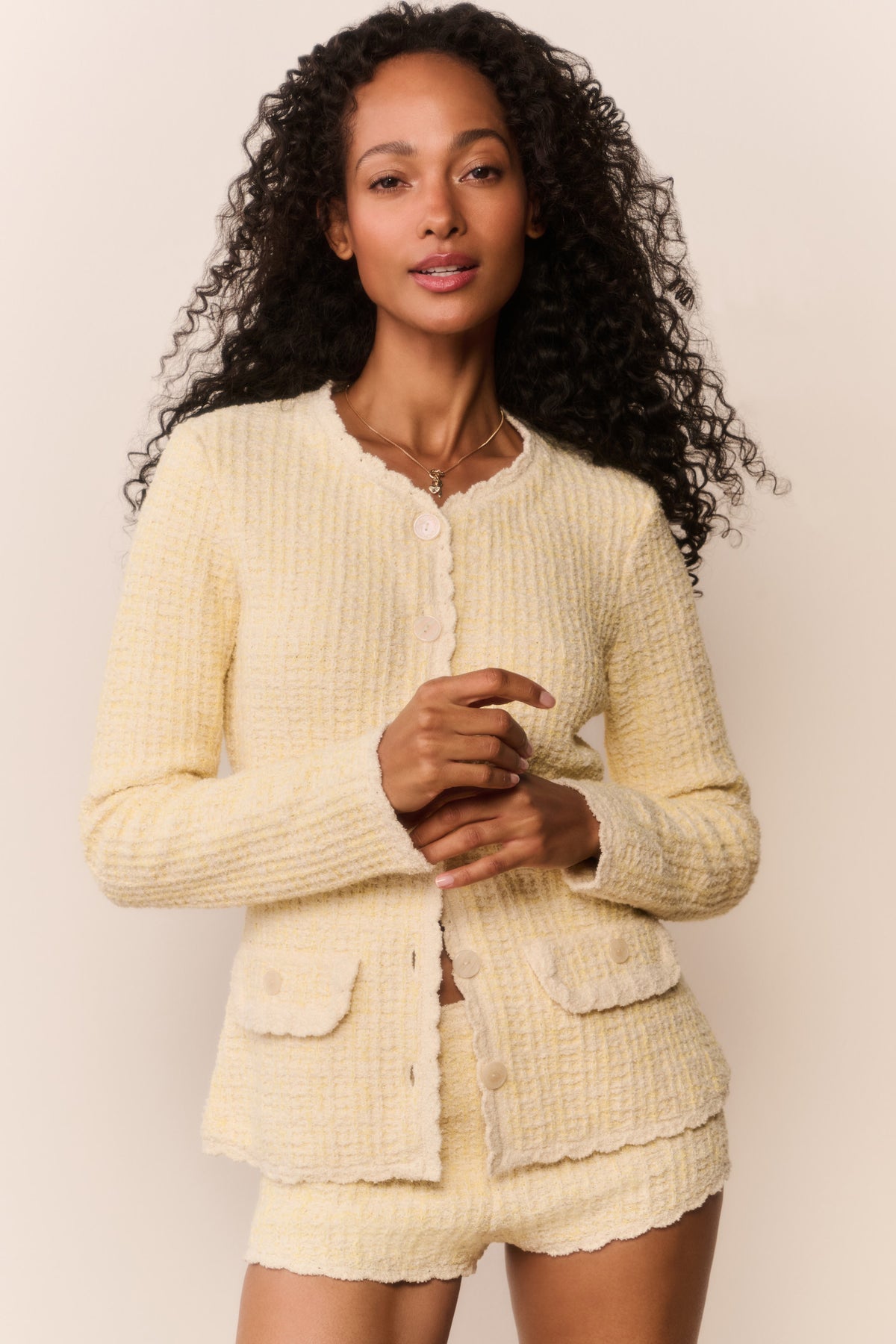 Yellow knit tweed cardigan with button front and patch pockets, close-up
