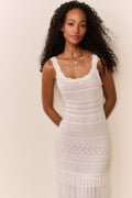 White knit pointelle maxi dress close-up: thin straps, scalloped neckline and textured panels