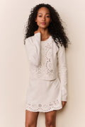 White eyelet knit cardigan 3/4 view with long sleeves and scalloped eyelet hem.