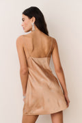 Gold satin mini dress with thin spaghetti straps and celestial crystal star print, back view