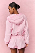 Pink gingham windbreaker shorts with elastic waistband and ruffled hem, back view