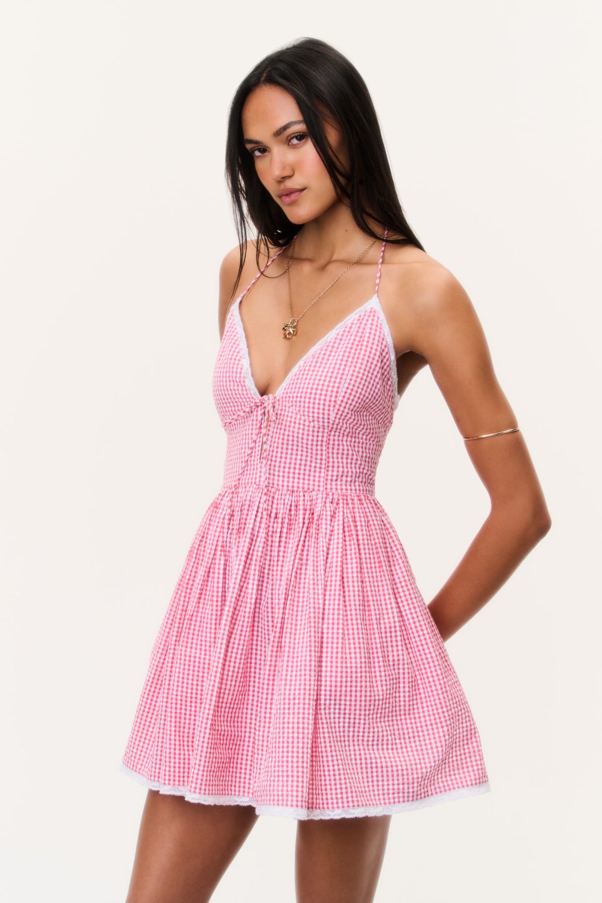 Pink gingham cotton mini dress with V-neck halter tie front and flared pleated skirt