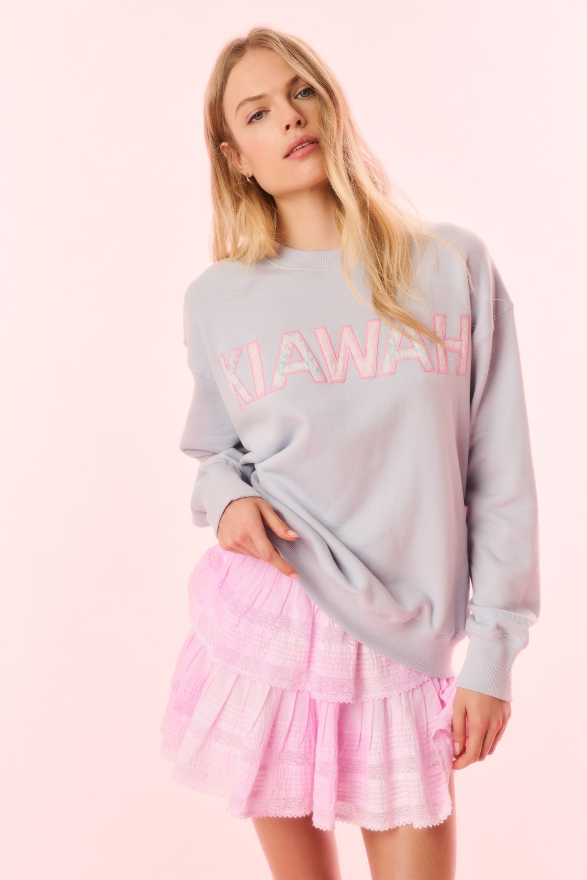 Light blue crewneck pullover sweatshirt with “KIAWAH” logo graphic on front