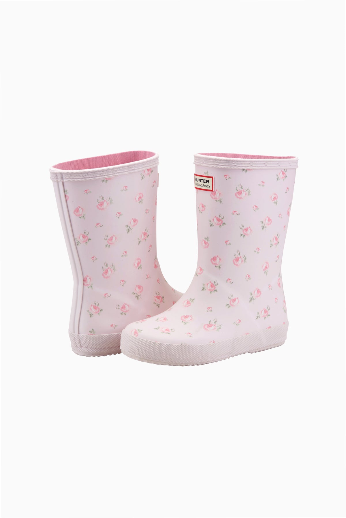 Pair of light pink floral kids rain boots with ruffled top cuffs
