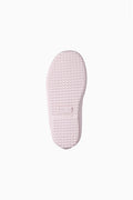 Light pink rain boot sole with textured tread bottom