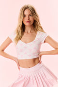 Cropped active top with V-neck and scattered pink bow print