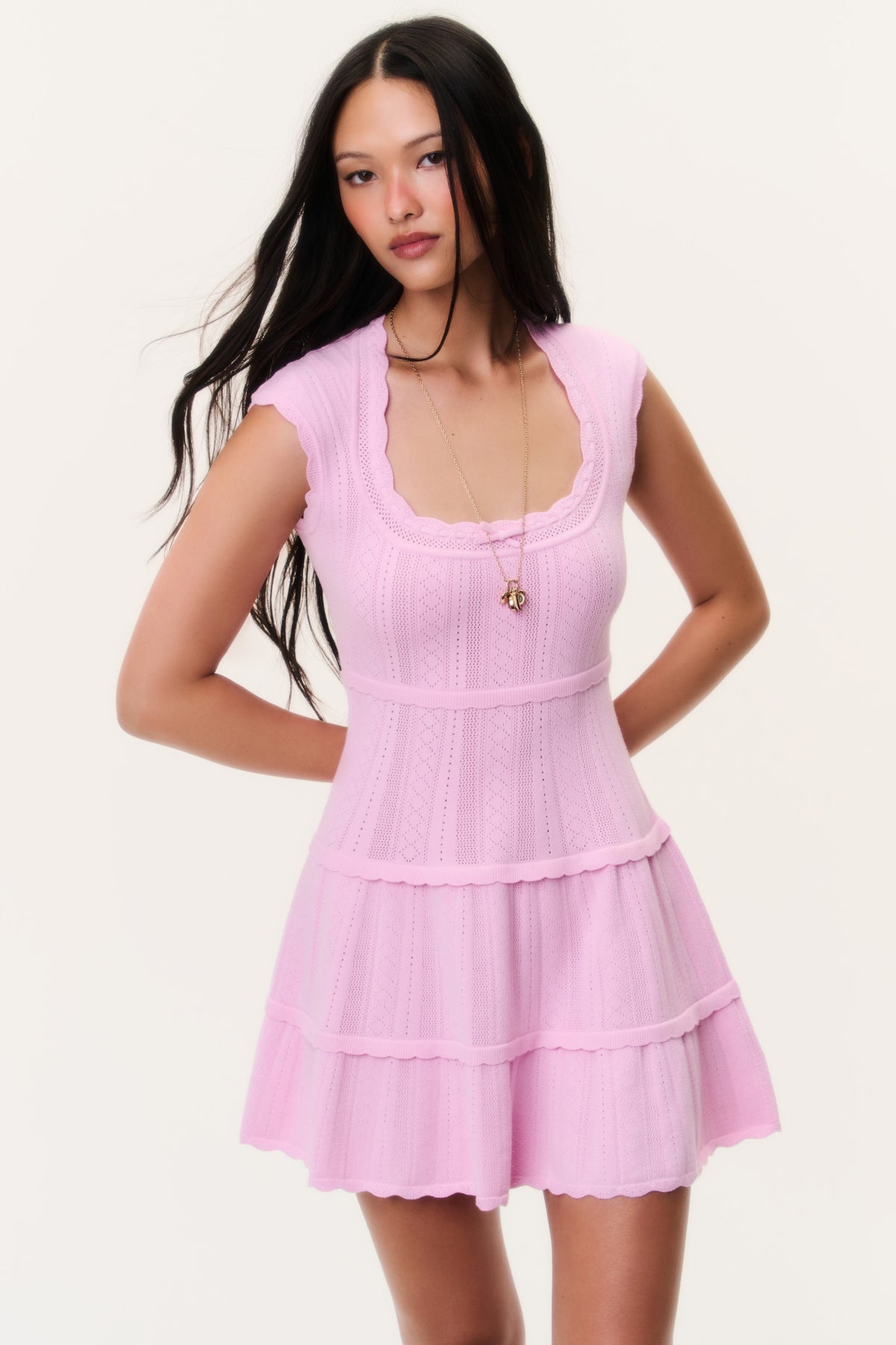 Candy pink pointelle mini dress with sleeveless scoop neck and tiered ruffle skirt