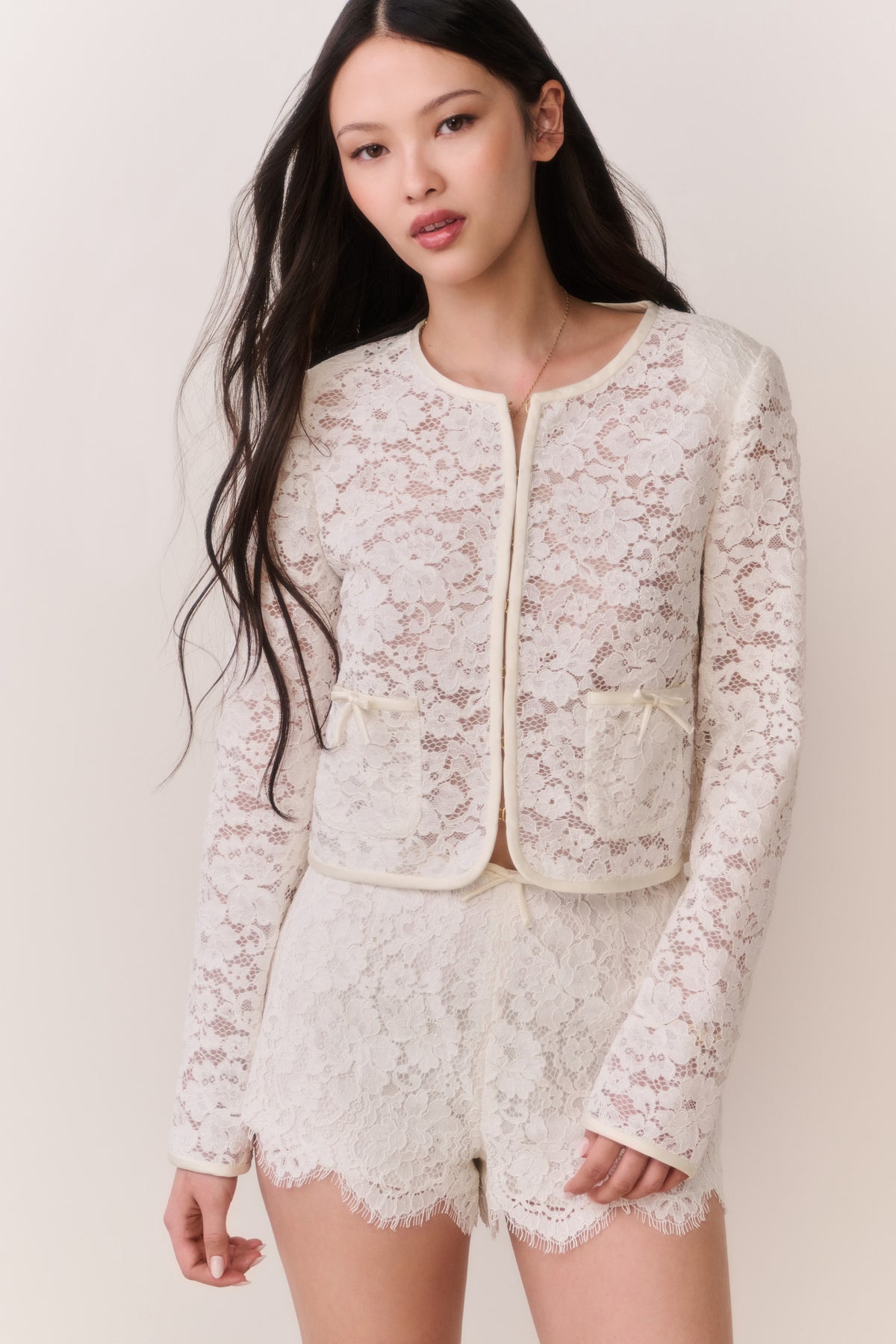Ivory lace mini shorts with scalloped edges and floral lace, front view