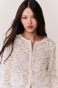 Ivory lace cropped jacket with long sleeves and cream-trimmed zipper front