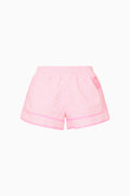 Pink gingham windbreaker shorts with elastic waistband and ruffled hem, front view